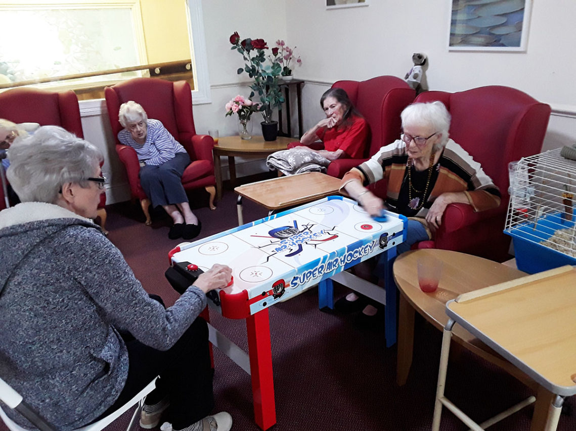 Residents playing air hockey at Lulworth House