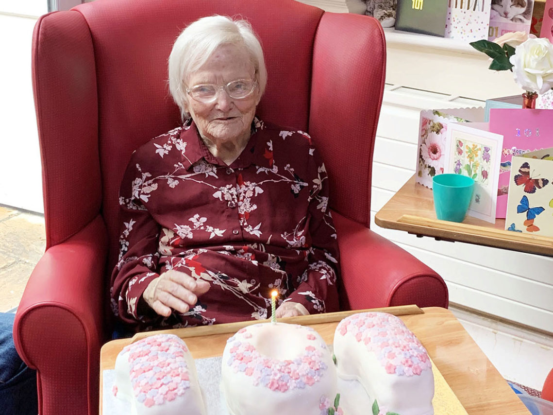 Lady resident at Lulworth House Residential Care Home with her 101st birthday cake