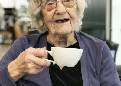 Female resident smiling and enjoying coffee in town