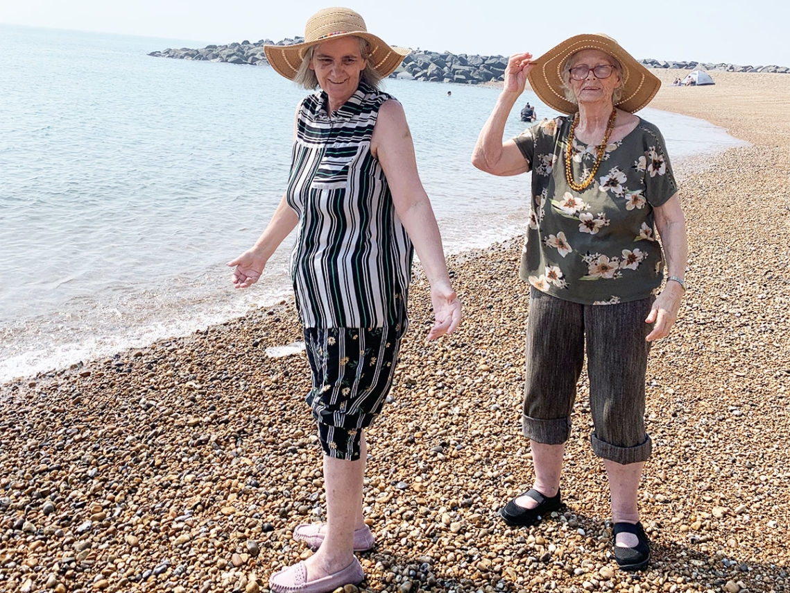 Lulworth House ladies in sun hats on the beach at the seaside
