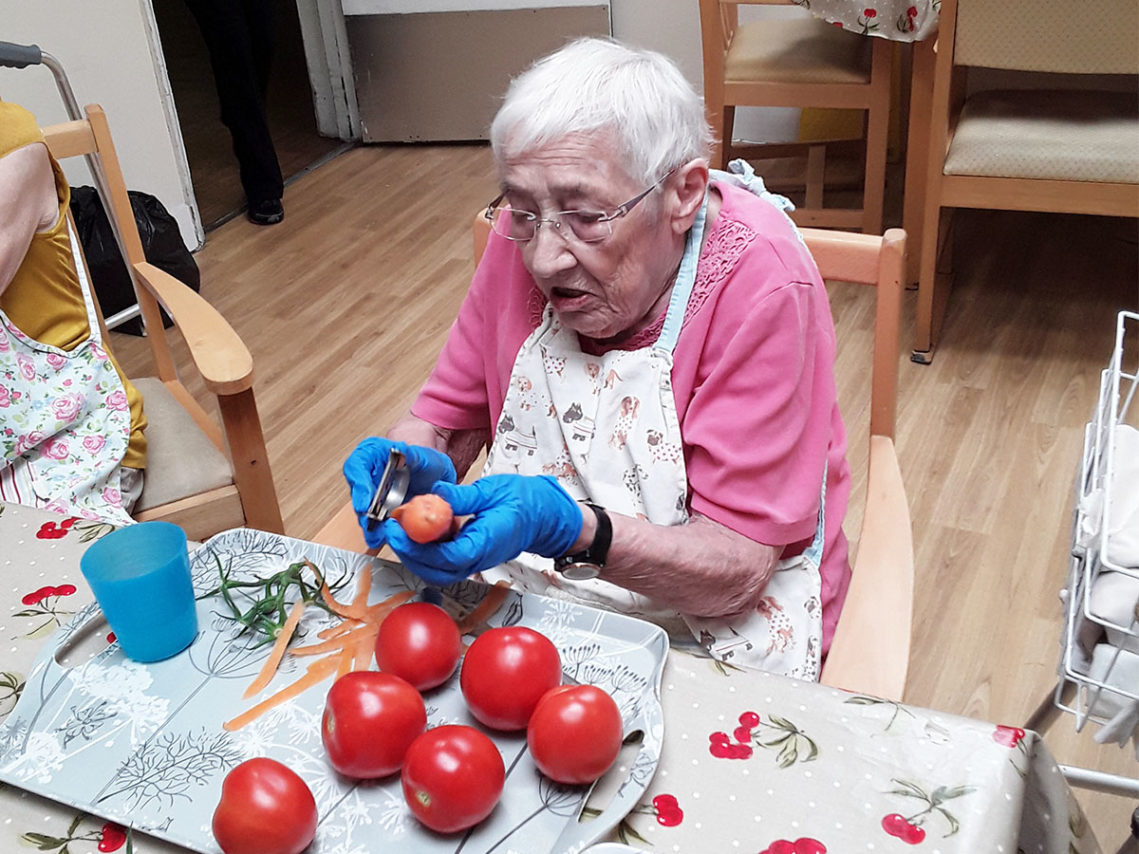 Lady resident prepping tomatoes to make soup