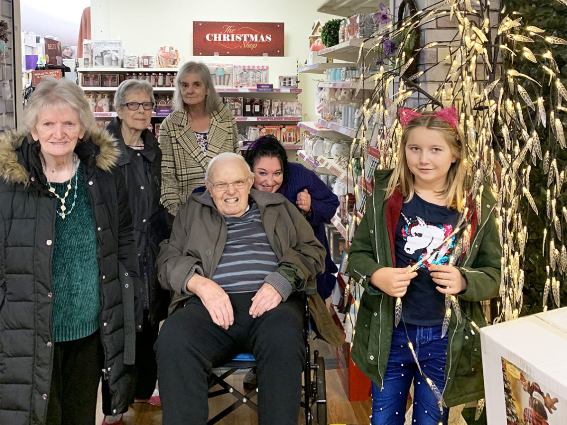 Lulworth residents and staff in a shop with Christmas decorations