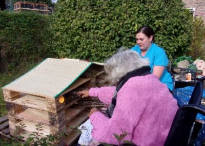Staff and residents constructing their newly built Bug Hotel at Loose Valley
