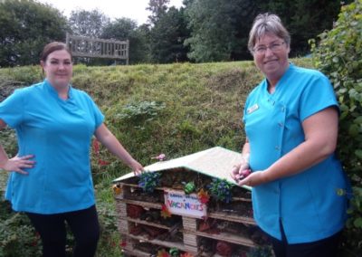Staff standing with their newly built Bug Hotel at Loose Valley