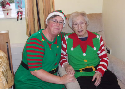 Loose Valley staff member and resident dressed as Christmas elves