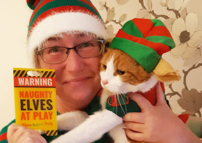 Staff member and her cat dressed as elves
