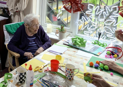 Lulworth House lady resident doing some Christmas crafts