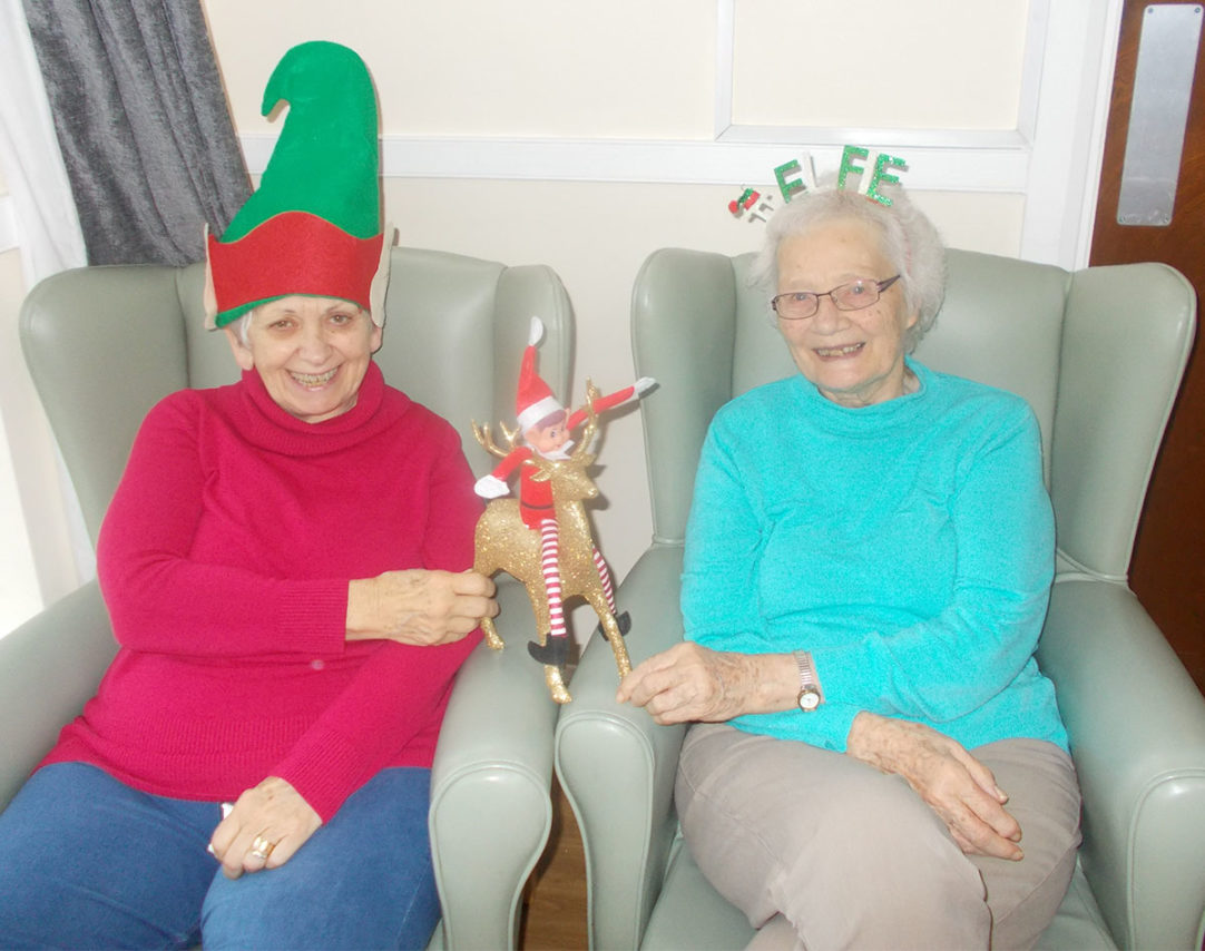 Two lady residents at Sonya Lodge with an elf and elf accessories
