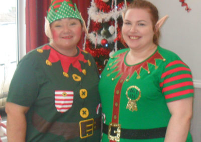 Two staff members at Woodstock dressed as Christmas elves