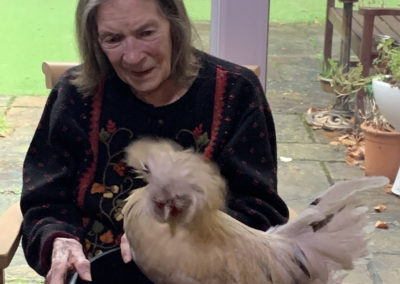 Lulworth House resident with a chicken