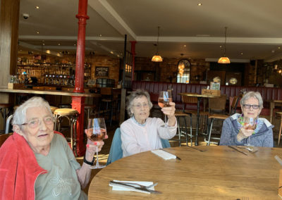 Lulworth lady residents rising their wine glasses to the camera at a local pub