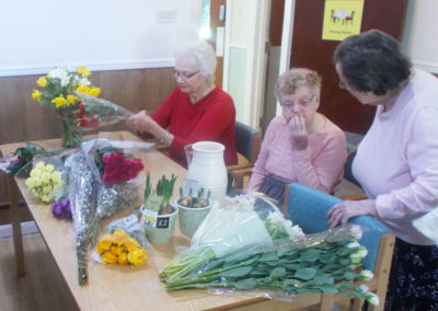 Residents at Sonya Lodge sorting fresh flowers for arranging