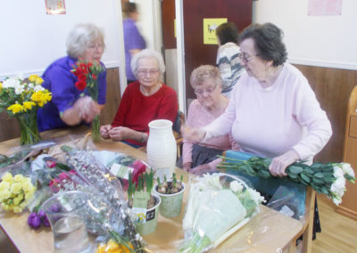 Residents at Sonya Lodge deciding how to arrange fresh flowers