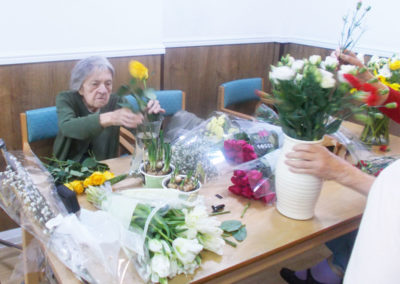 Residents at Sonya Lodge arranging fresh flowers in vases