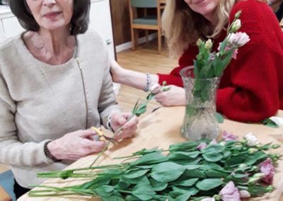 Lady resident and daughter at Sonya Lodge Residential Care Home flower arranging together