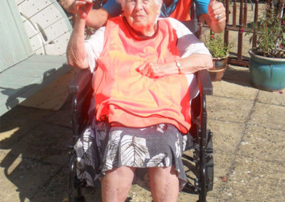 Resident receiving a trophy at Woodstock Residential Care Home