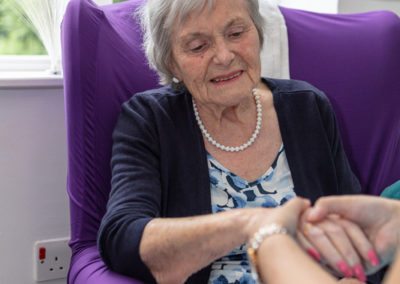 Princess Christian residents enjoying being pampered with a hand and face massage